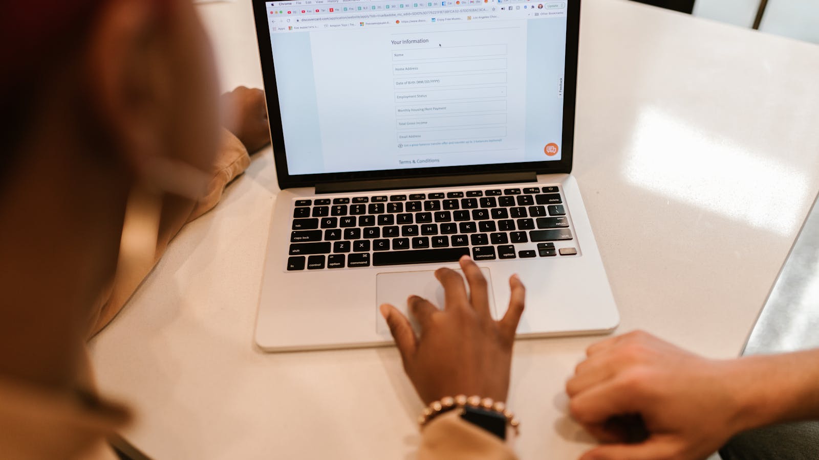 Form kontak website sedang diuji di ponsel dengan laptop dan checklist audit teknis di meja kerja.